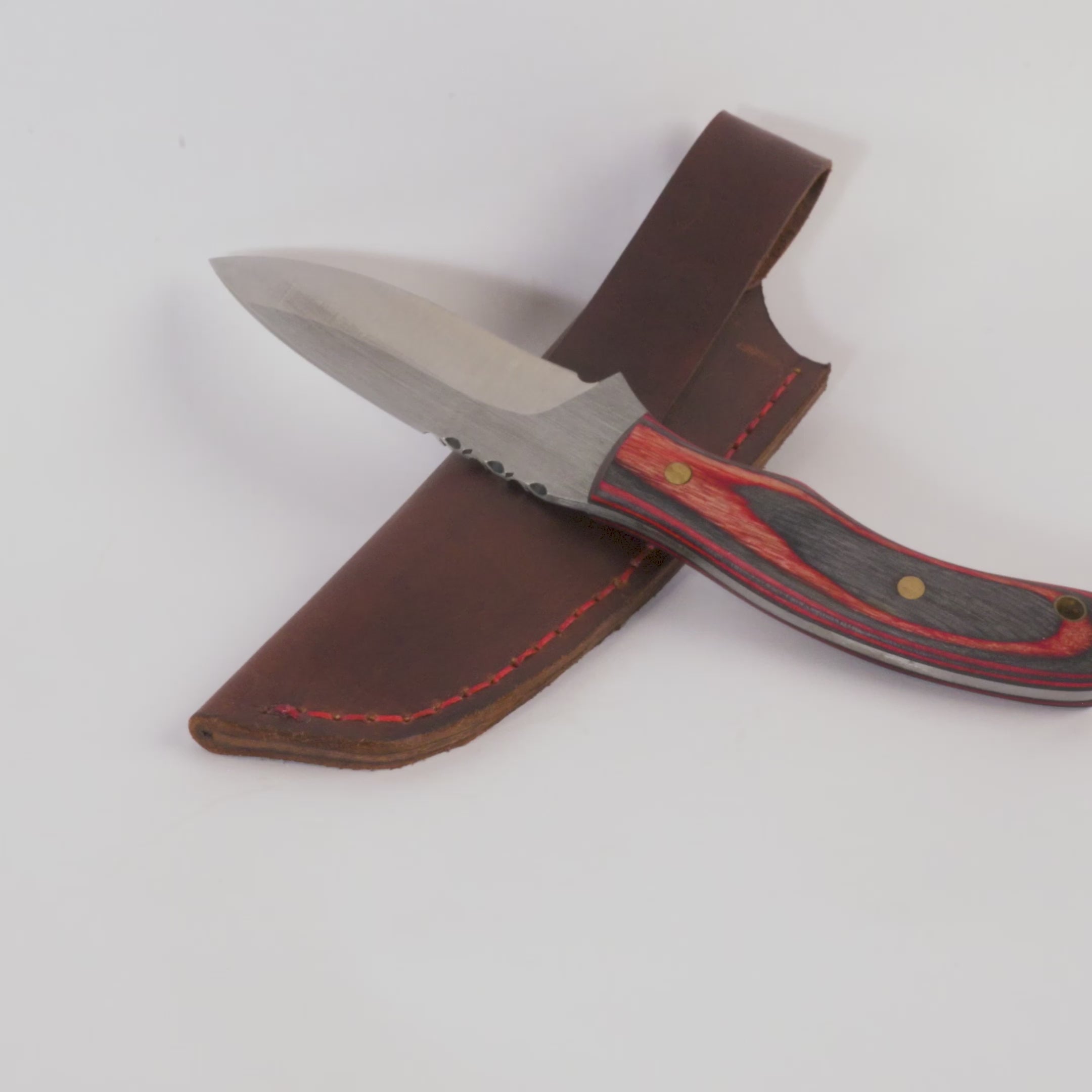 Knife with a wooden handle and leather sheath on a white background