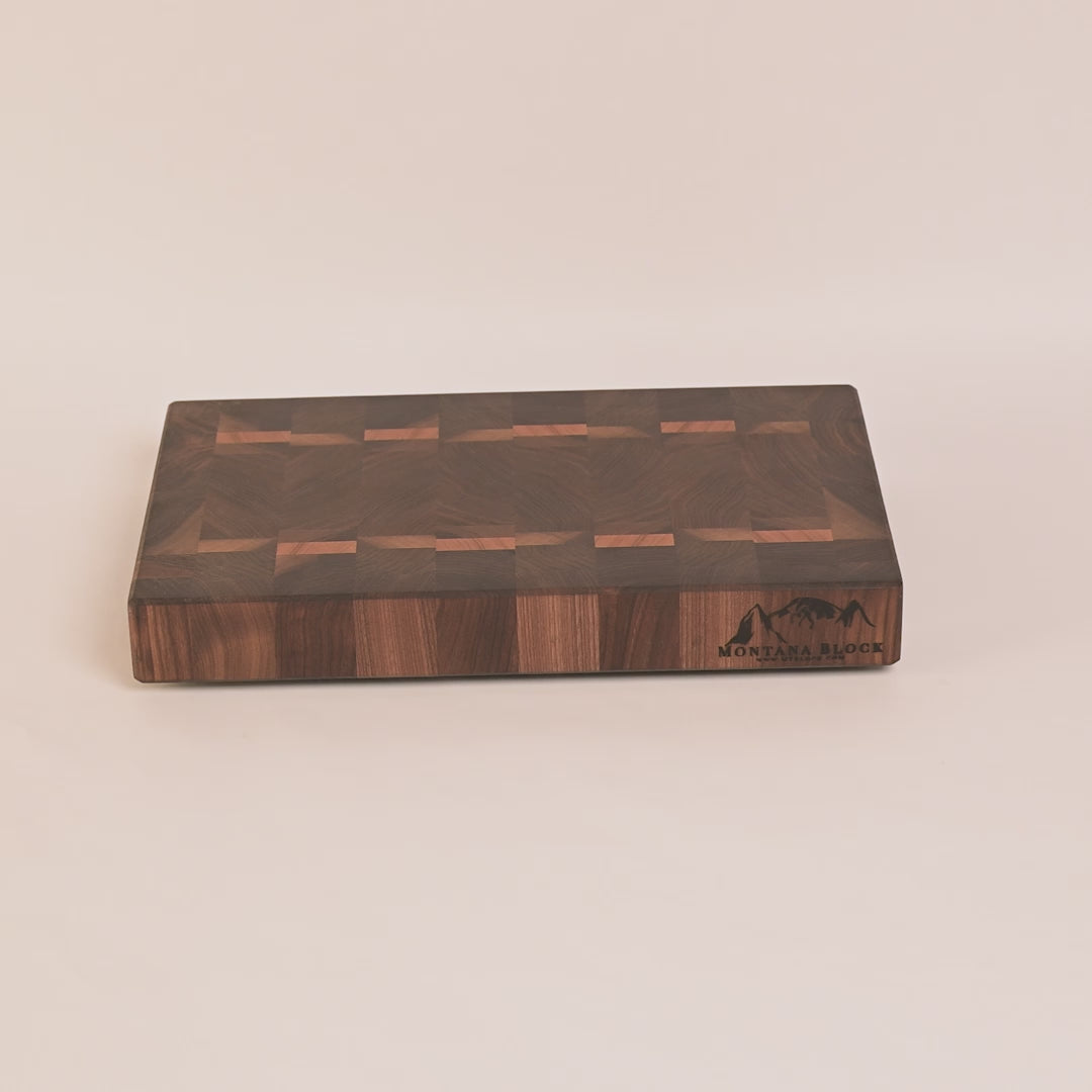 Wooden cutting board with a checkered pattern on a white background