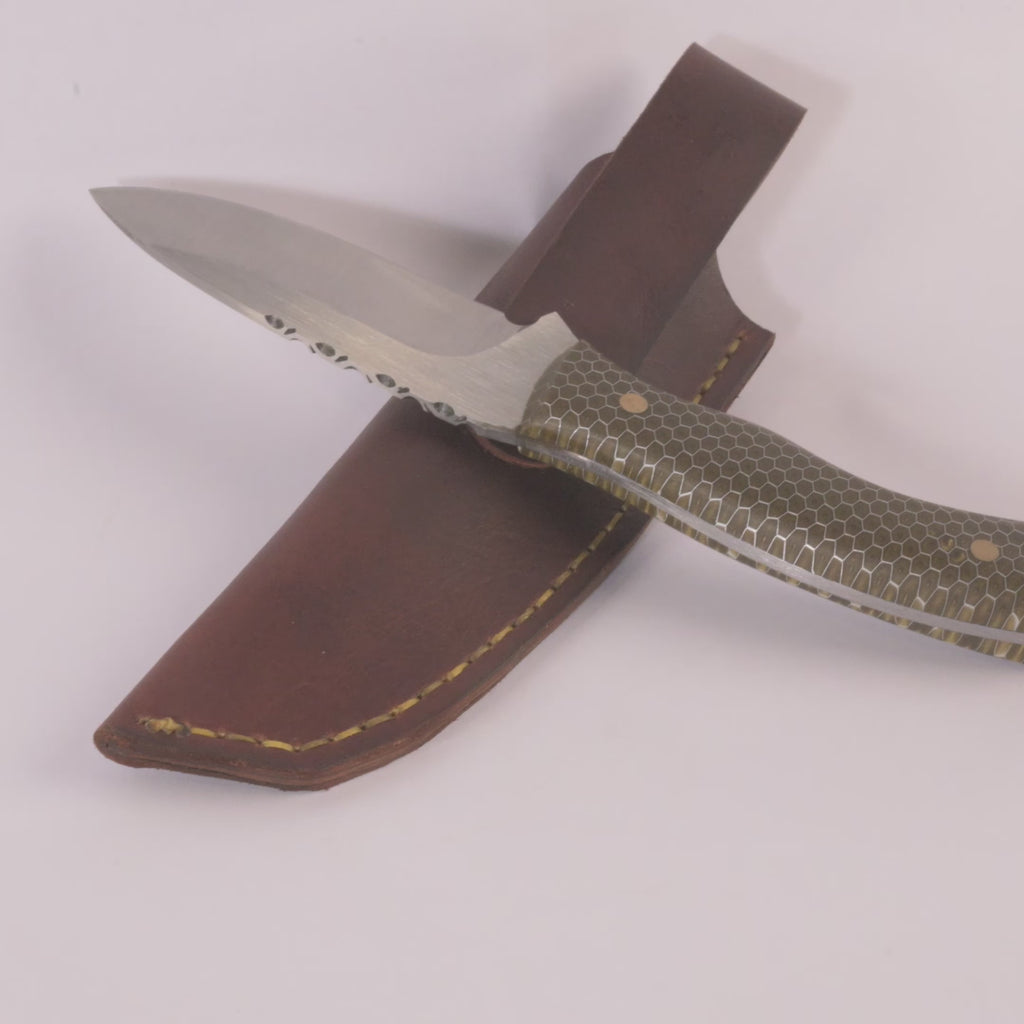 knife with steel blade and honeycomb patterned handle with a leather sheath on a white background