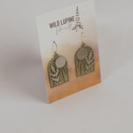 Pair of earrings on a Wild Lupine Folkcraft branded card with a gradient background.