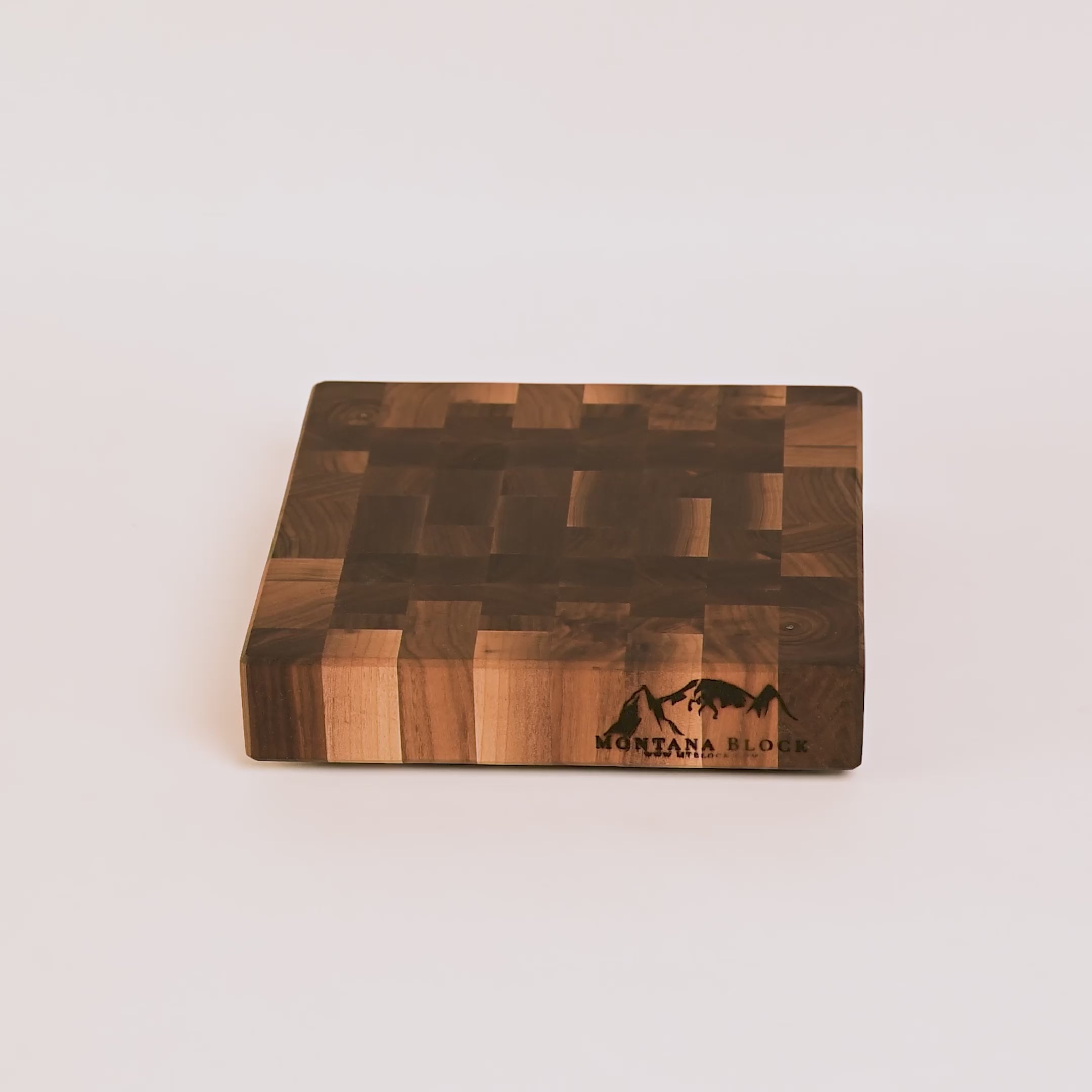 Wooden cutting board with a checkered pattern and 'Montana Block' branding on a white background