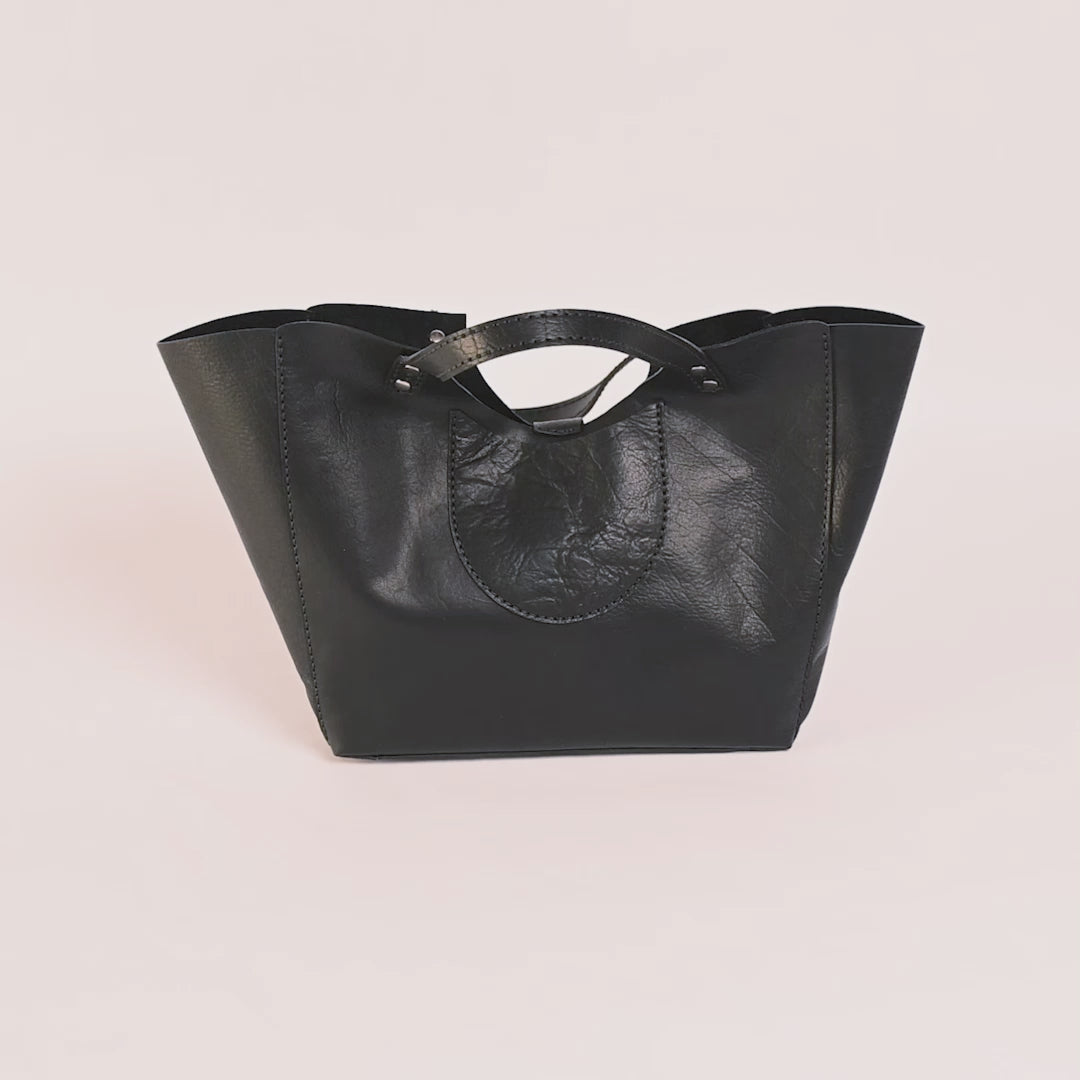 Black leather handbag on a white background