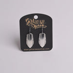 Silver earrings on a 'Girl Run Away with the Spoon' branded card.