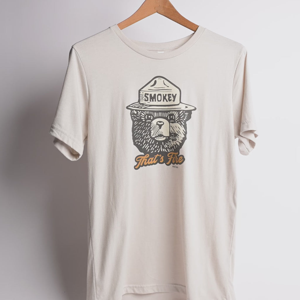 Beige t-shirt with Smokey Bear graphic on a white background