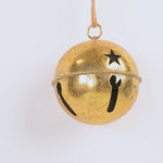 Gold bell with star design on a white background