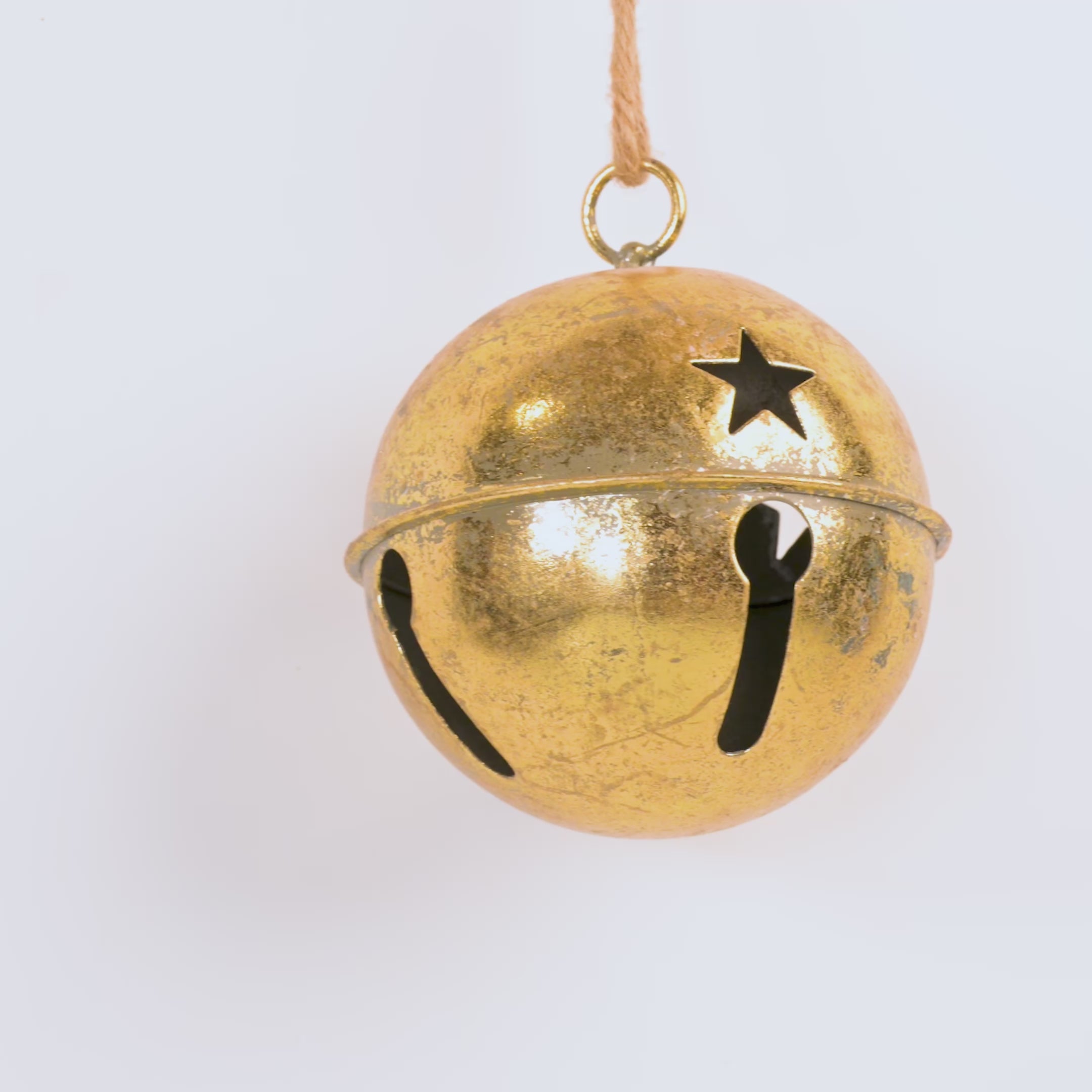 Gold bell with star design on a white background