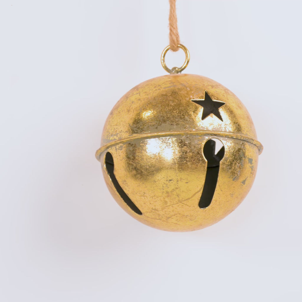 Gold bell with star design on a white background