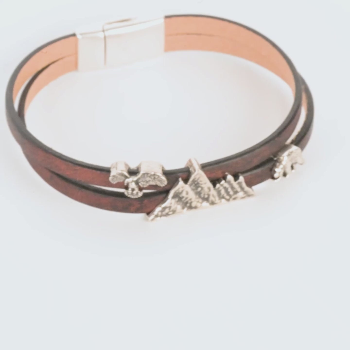 Bracelet with mountain-shaped charms on a white background