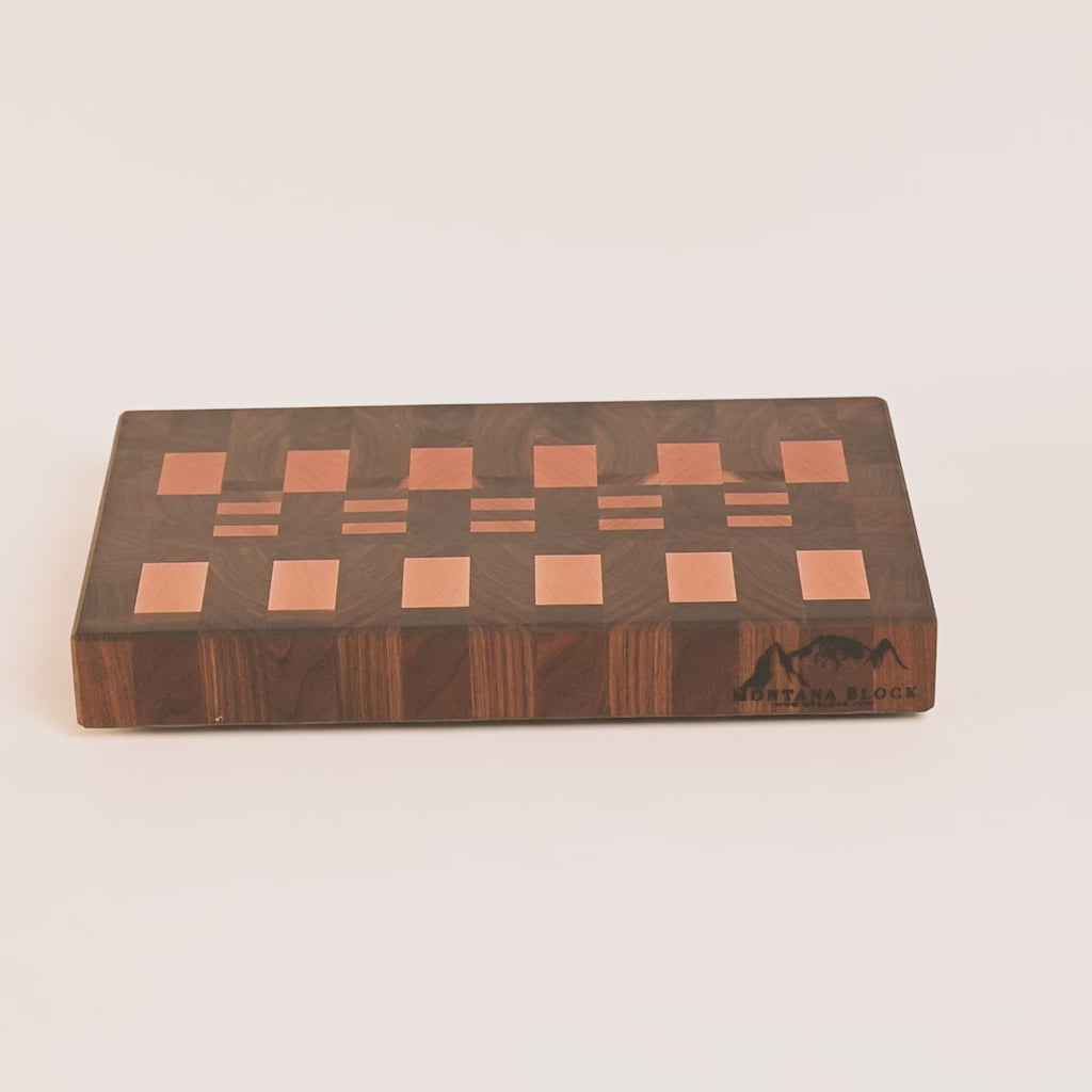 Wooden cutting board with a checkered pattern on a white background