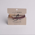 beaded wrap bracelets in gold and dark burgundy on a kraft paper display card from Lady Bird.