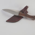 Knife with wooden handle and leather sheath on a white background