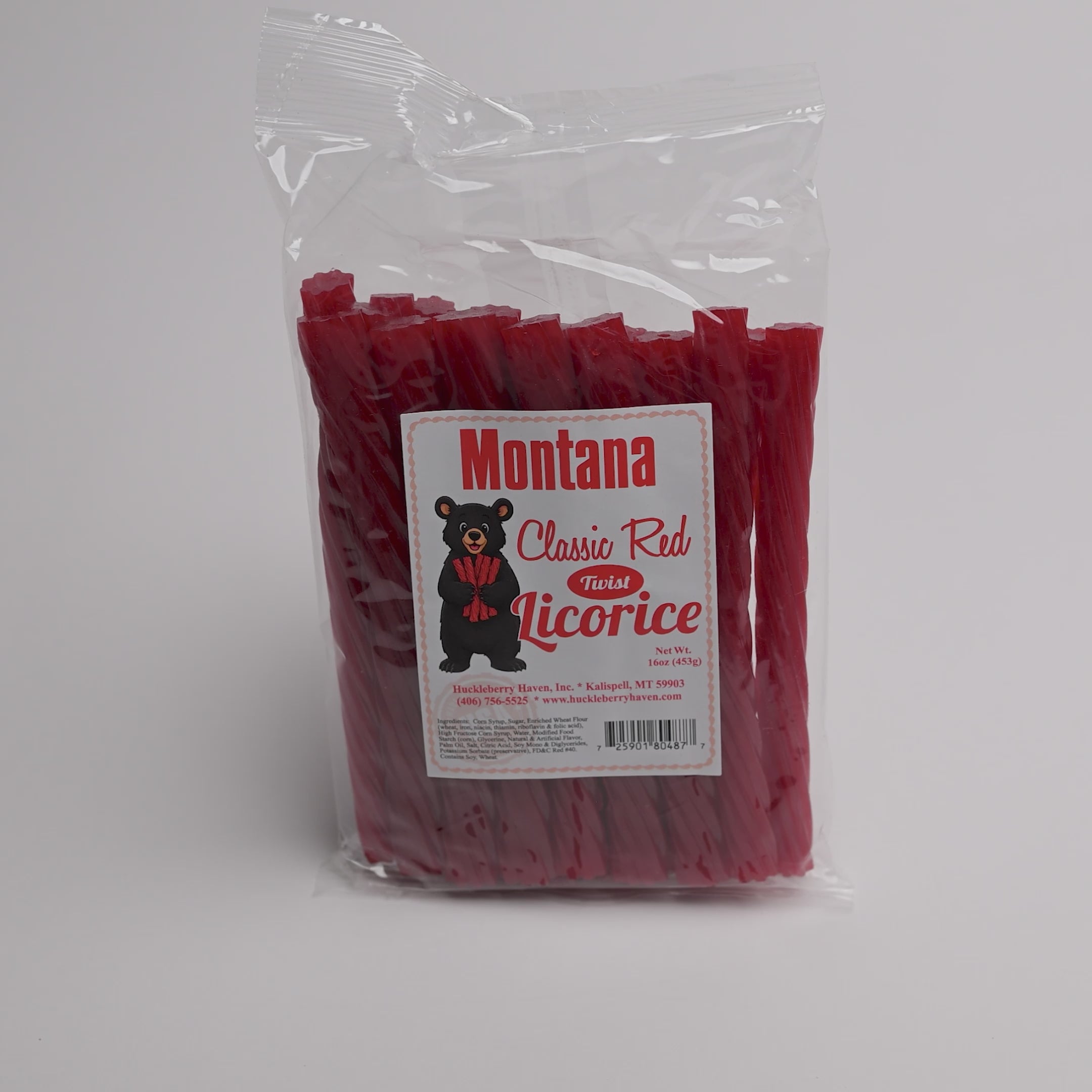 A clear plastic bag of Montana Classic Red Fossil Licorice, showing the red licorice sticks inside. The front features a white label with a black bear logo and red text.
