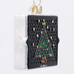 Decorative ornament shaped like a Lite-Brite with a Christmas tree design on a white background
