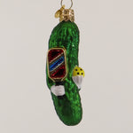 Decorative pickle ornament with a pickleball paddle on a white background