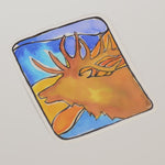 Sticker with a colorful design of a elk head on a blue and orange background
