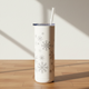 White tumbler with snowflake patterns on a wooden surface