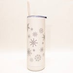 White tumbler with snowflake patterns on a white background