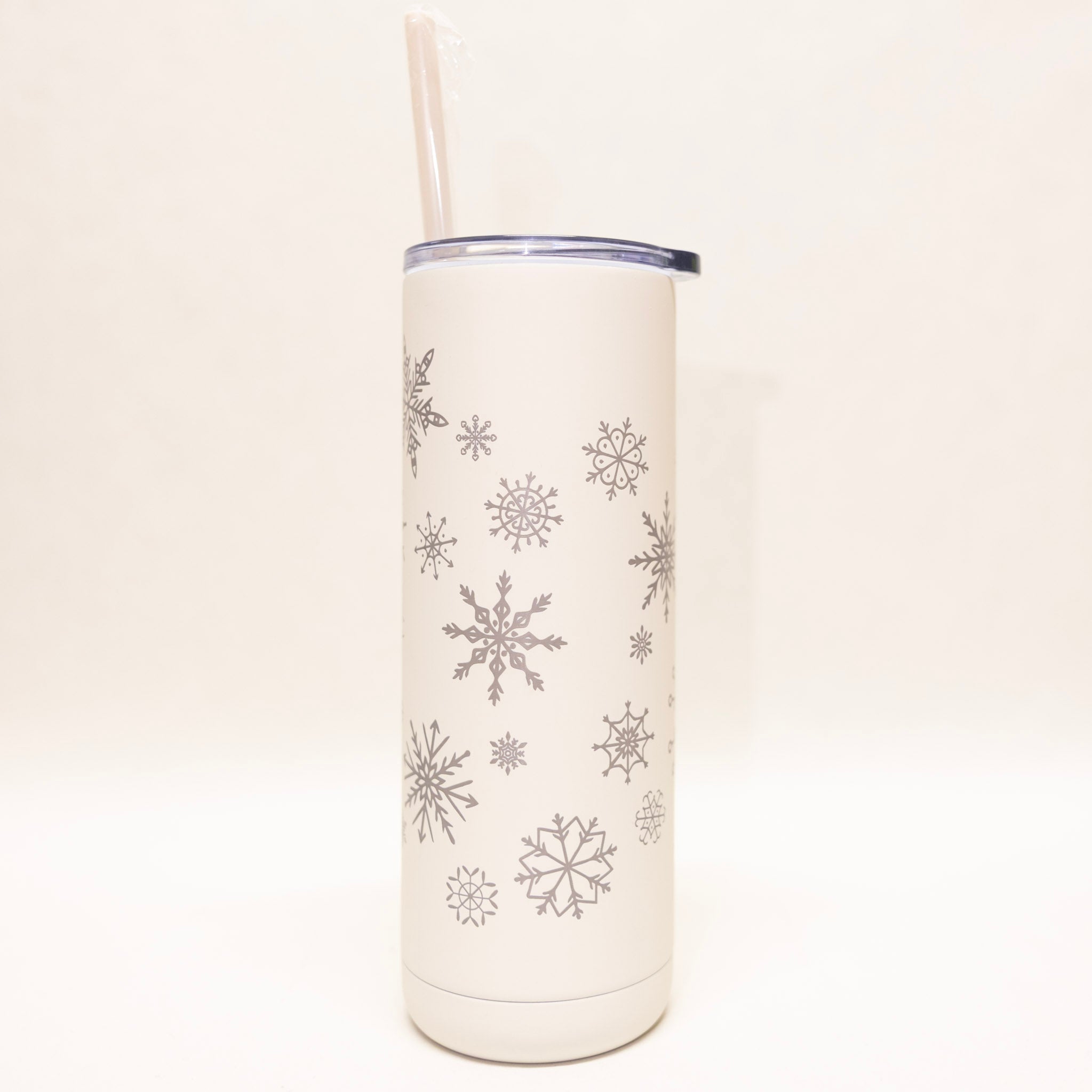 White tumbler with snowflake patterns on a white background