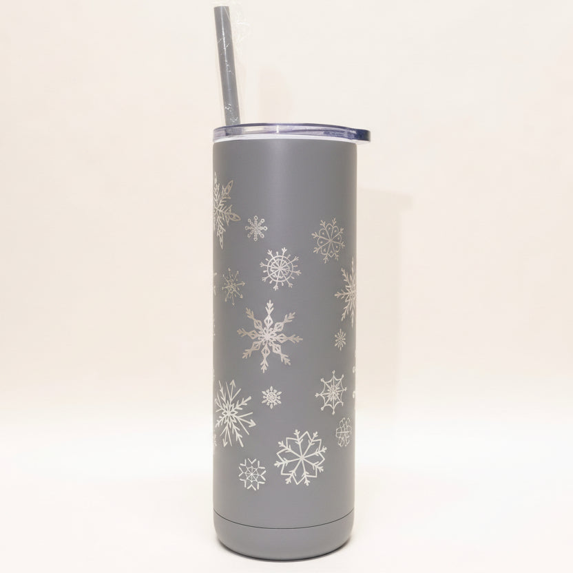 White tumbler with snowflake patterns on a white background