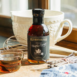 Bottle of Wild Montana Foods Maple Syrup in a rustic kitchen