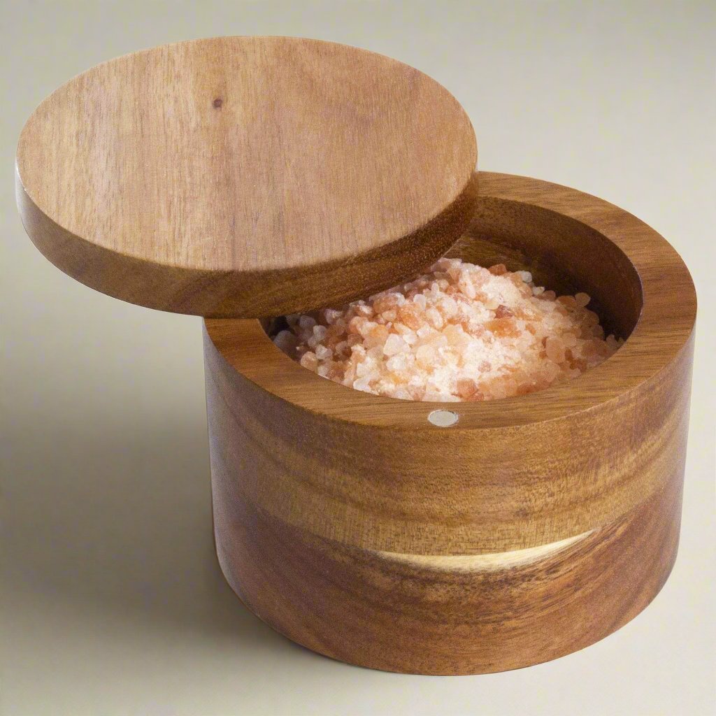 The Acacia Salt Box by Totally Bamboo is a stunning dark wood cylindrical container with a magnetic lid closure.