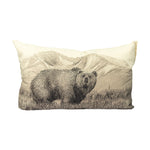 bear in a field with a mountain view