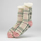 Plaid patterned socks with pink accents on a light gray background