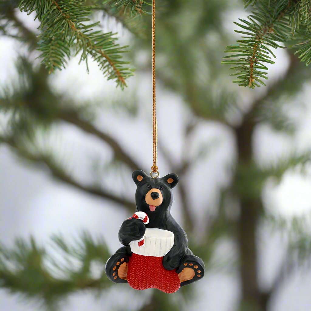 The Bearfoots Taste of Christmas Ornament by Big Sky Carvers brings you a heartwarming bearfoots bear having a taste of a Christmas candy cane! 