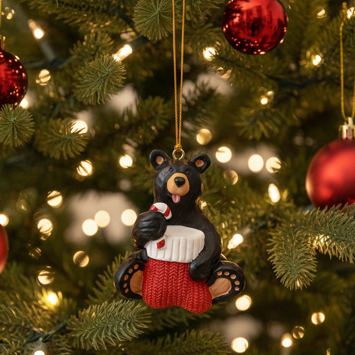 The Bearfoots Taste of Christmas Ornament by Big Sky Carvers brings you a heartwarming bearfoots bear having a taste of a Christmas candy cane! 