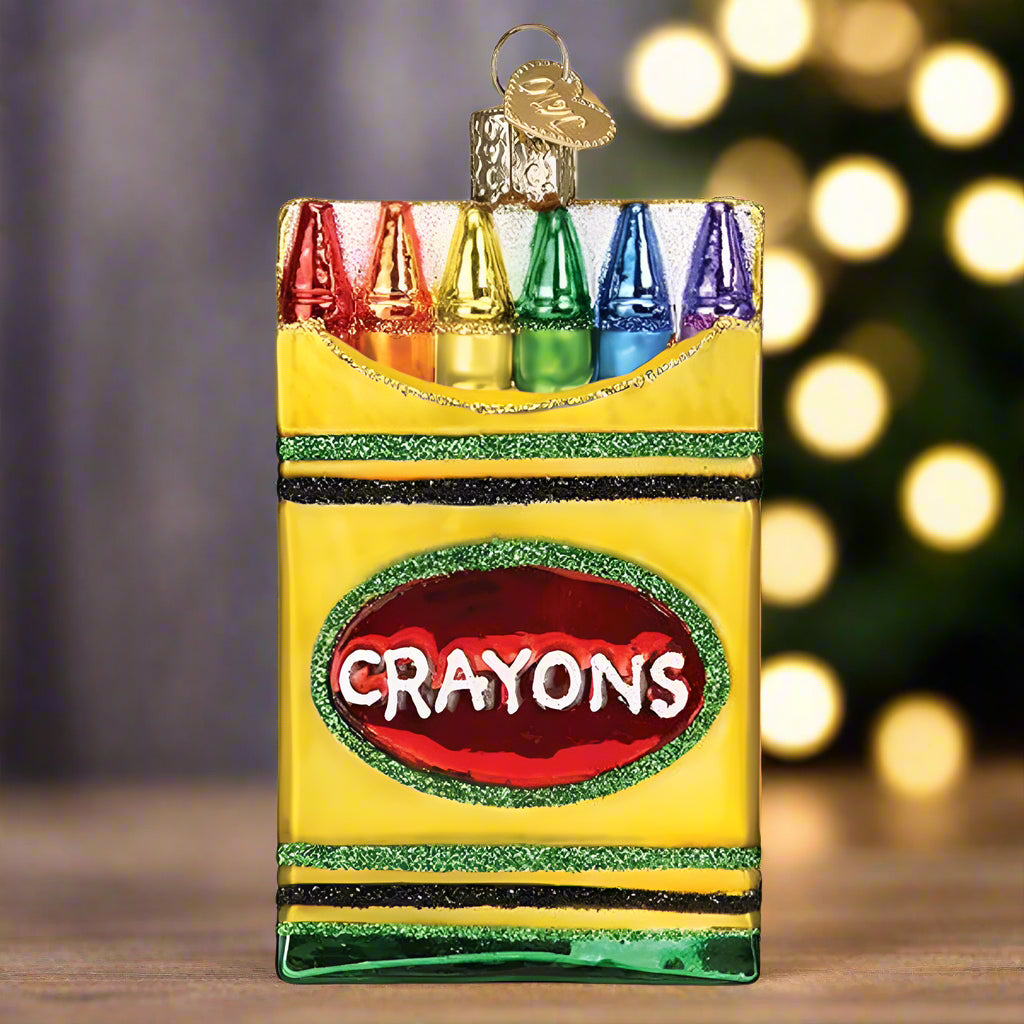 The Box of Crayons Ornament by Old World Christmas features a full set of glittered crayons and that bright yellow box we all know and love.