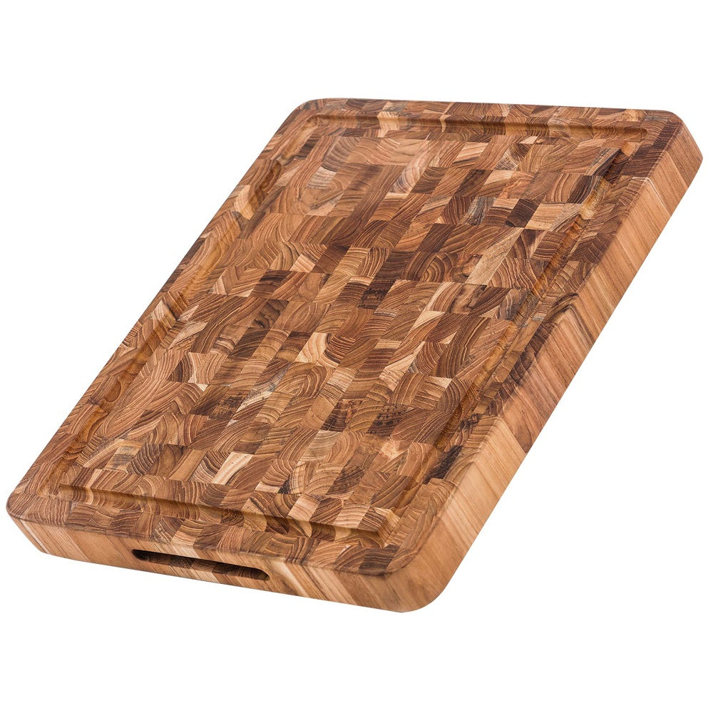 The Butcher Block Carving and Cutting Board by Teak Haus is a stunning reversible ten pound butcher block that features a hand grip and a juice canal.