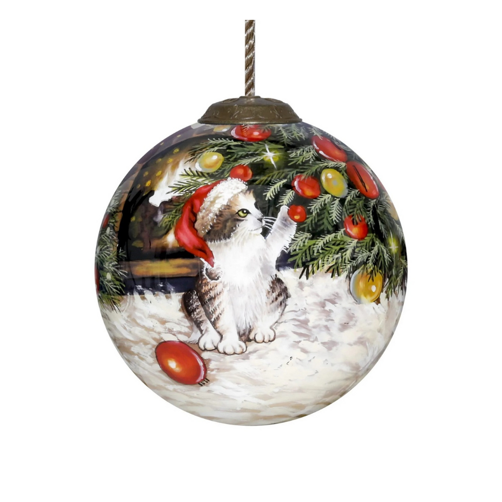  The Christmas Kitten Round Ornament by Inner Beauty features a kitten playing under the Christmas tree as he wears a Santa hat. 