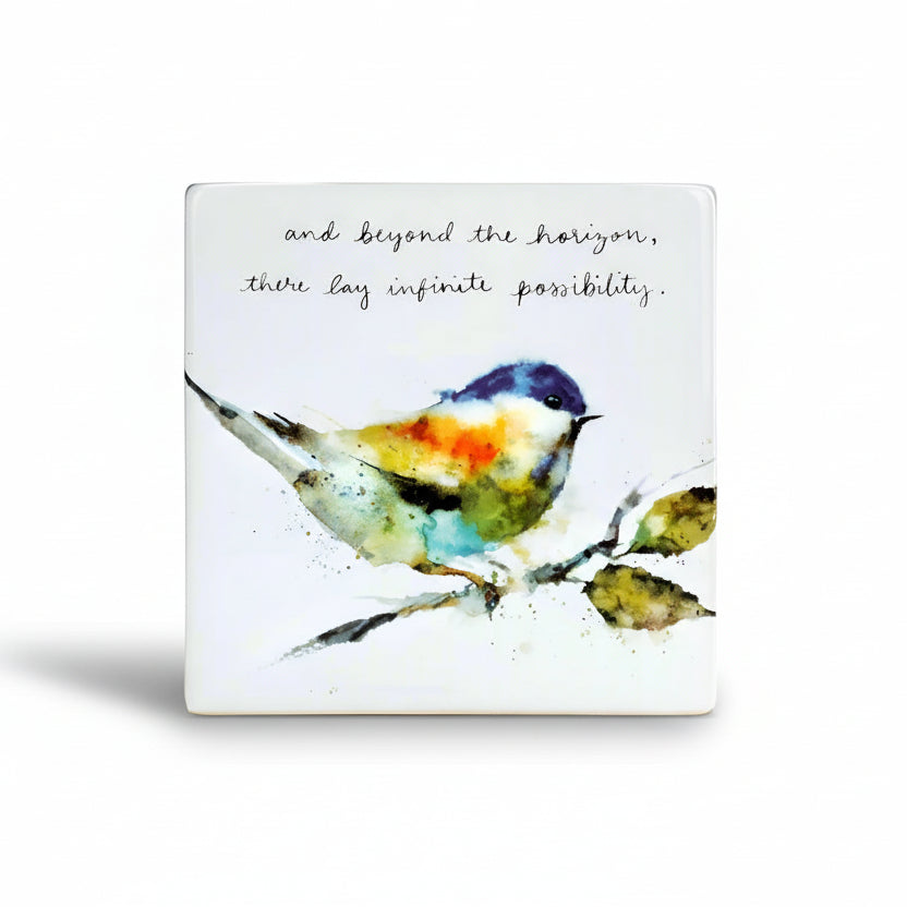 Decorative tile with a watercolor bird illustration and motivational quote on a white background