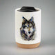 Enjoy the colorful and stylish art of Dean Crouser while you sip a warm drink with the Dean Crouser Cork Bottom Bone Tumbler by Demdaco.