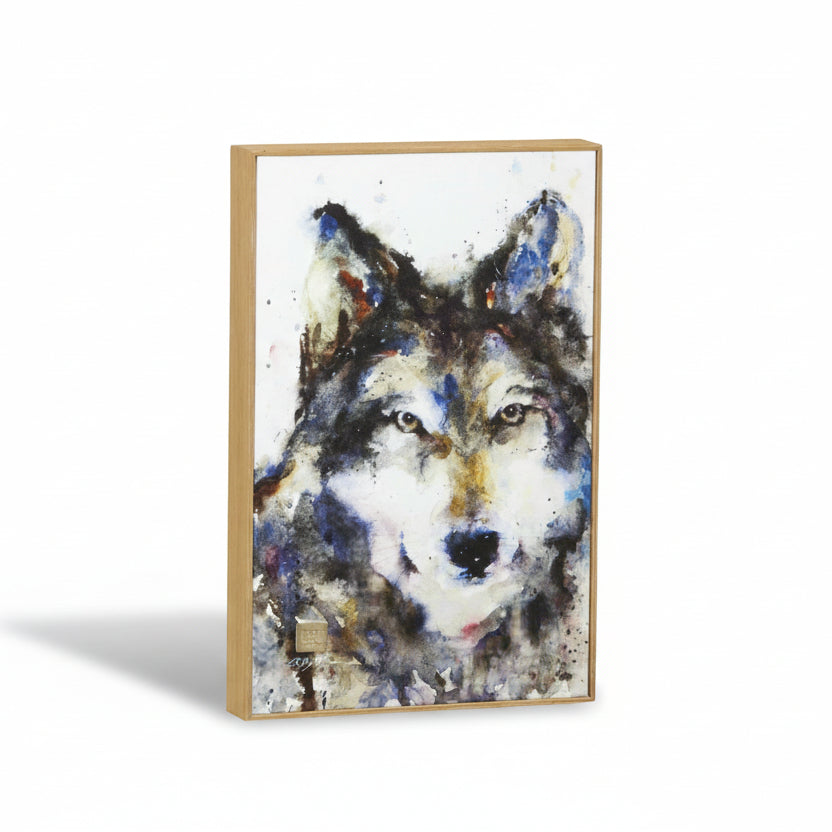 A colorful watercolor painting of a wolf on a canvas, with a sawtooth style wooden frame.