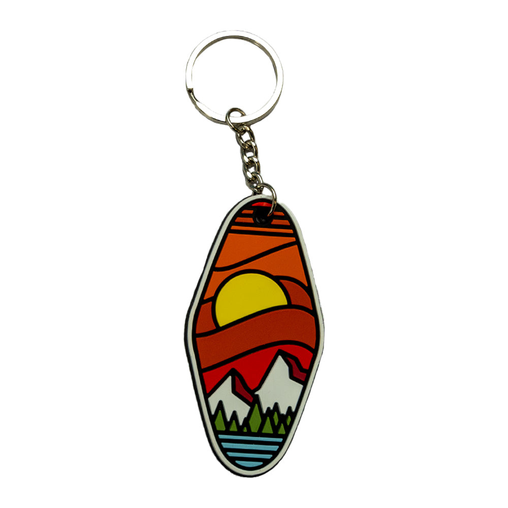 Colorful keychain shaped like a classic hotel keychain, features a sunset over a mountain scene.