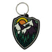 this shield shape mountain scene keychain features a sunset over a mountain and forest