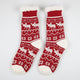 Red socks with white moose pattern on a white background