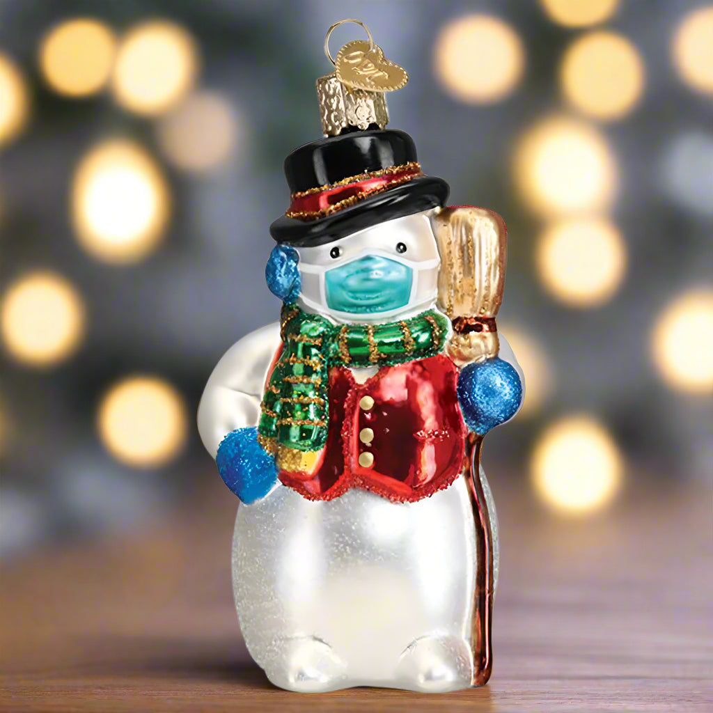 The Snowman with Face Mask Ornament by Old World Christmas is a wonderfully funny ornament for your tree. 