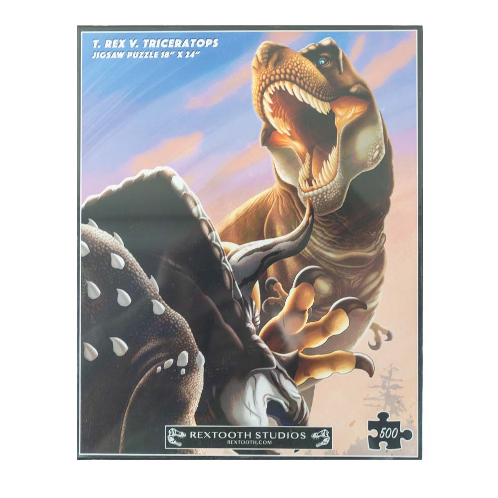 The T. Rex vs. Triceratops Jigsaw Puzzle by Rextooth Studios features stunning artwork by Ted Rechlin which creates a thrilling scene of a deadly fight.