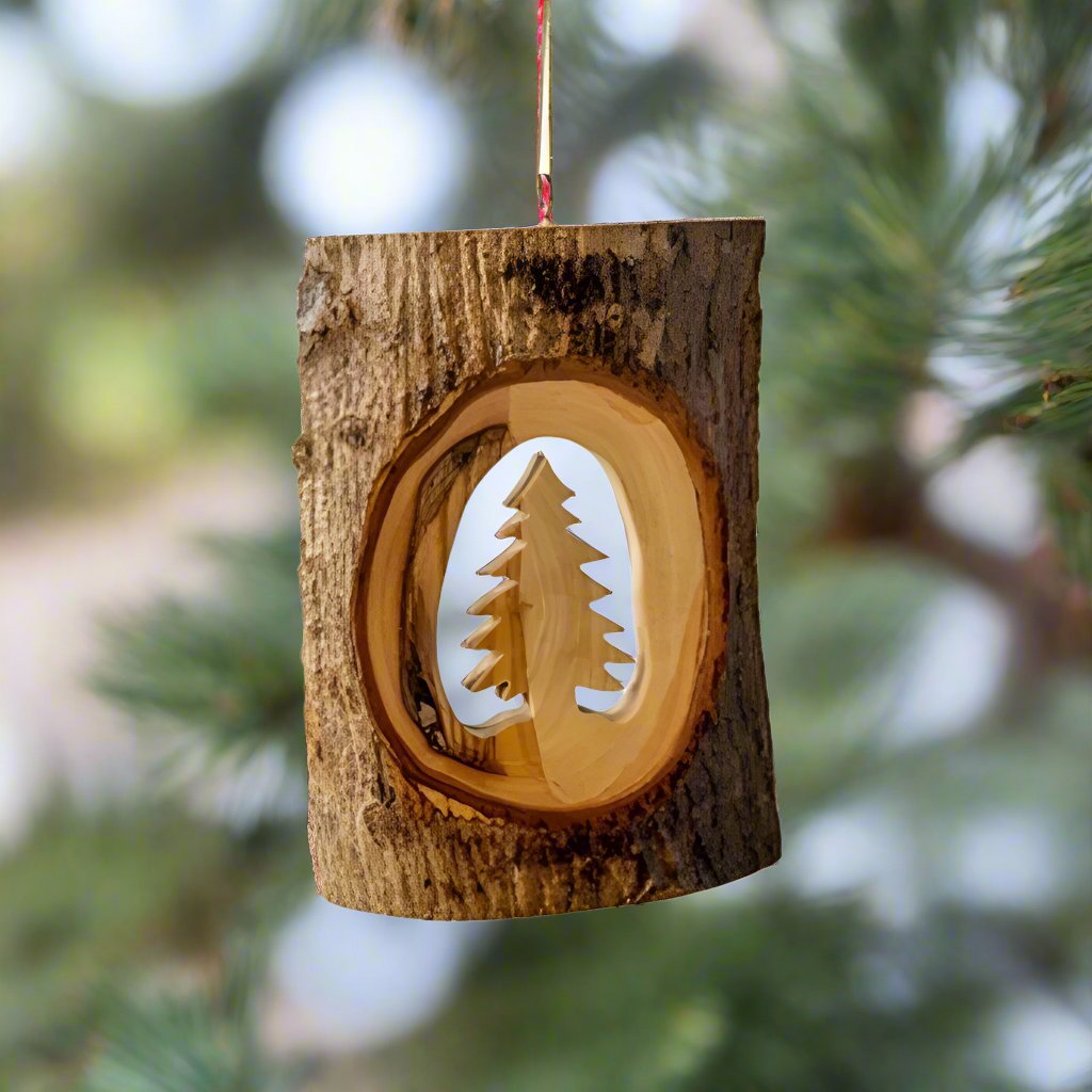The Tree Bark with Christmas Tree Ornament by Earthwood is a stunning wooden ornament that features its origin in it's center.