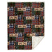 tree plaid sherpa throw blanket by carstens features a patchwork design of different plaids, one is a green, one is red, one is light grey and black, and one is different colors of brown. It also features pine trees, pine cones, and leaves
