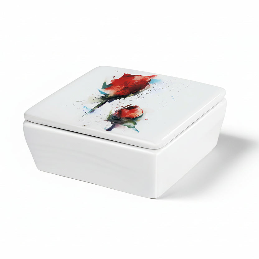 A white ceramic vanity box with a lid, featuring a red rose design painted on the top.