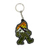 keychain shaped like a yeti with a sunset design over a mountain view and a forest