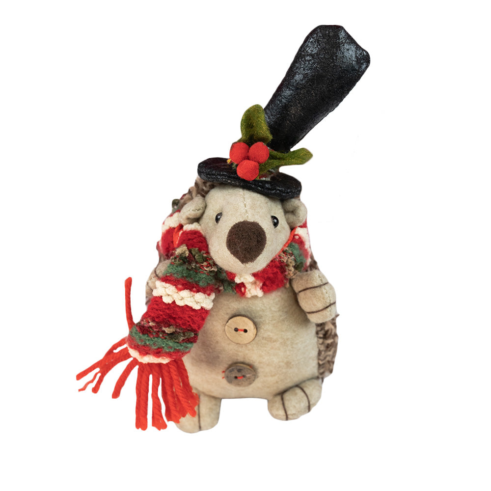 Hedgey the Standing Hedgehog by Oak Street Wholesale is a Christmas themed hedgehog who dons his favorite holiday scarf and hat before journeying out in the cold. 